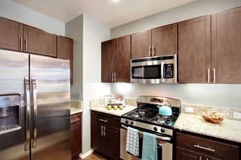 A kitchen with stainless steel appliances and granite counter tops